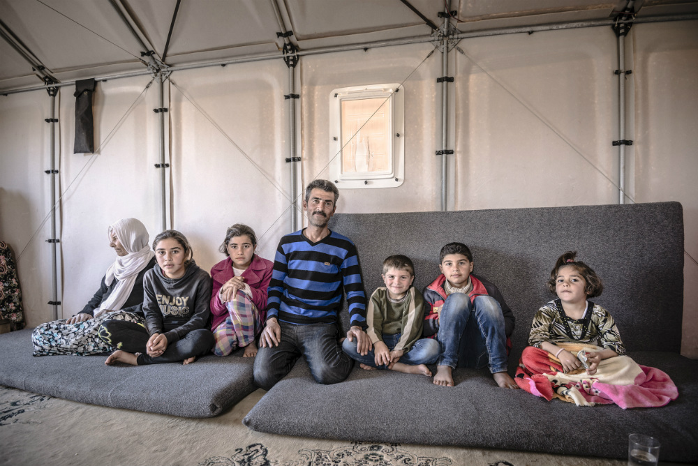 A family inside a prototype shelter in Kawergosk Refugee Camp, Iraq, in March. Refugee feedback has been crucial to the design process. Better Shelter interviewed former refugee camp residents now living in Sweden. Then it asked refugees about their cultural and environmental concerns during pilots in Ethiopia and Iraq 
