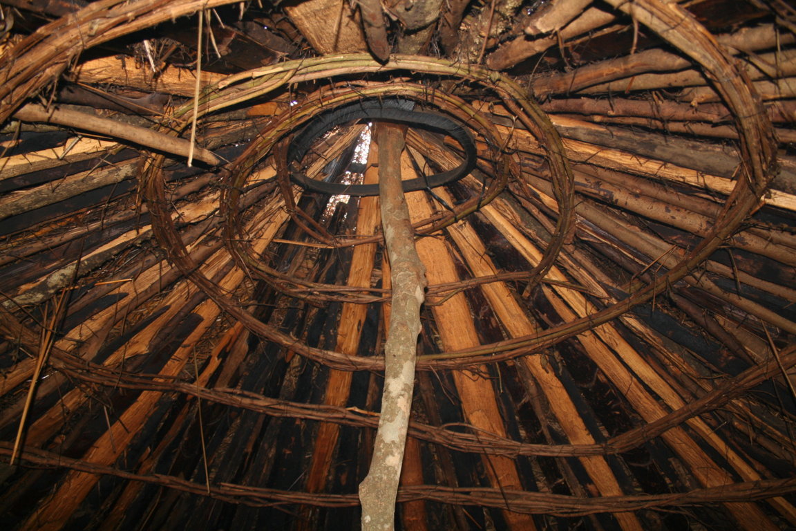 The simple arrangement of a gap in the thatch roofing provides an exit for smoke in a traditional hut.
