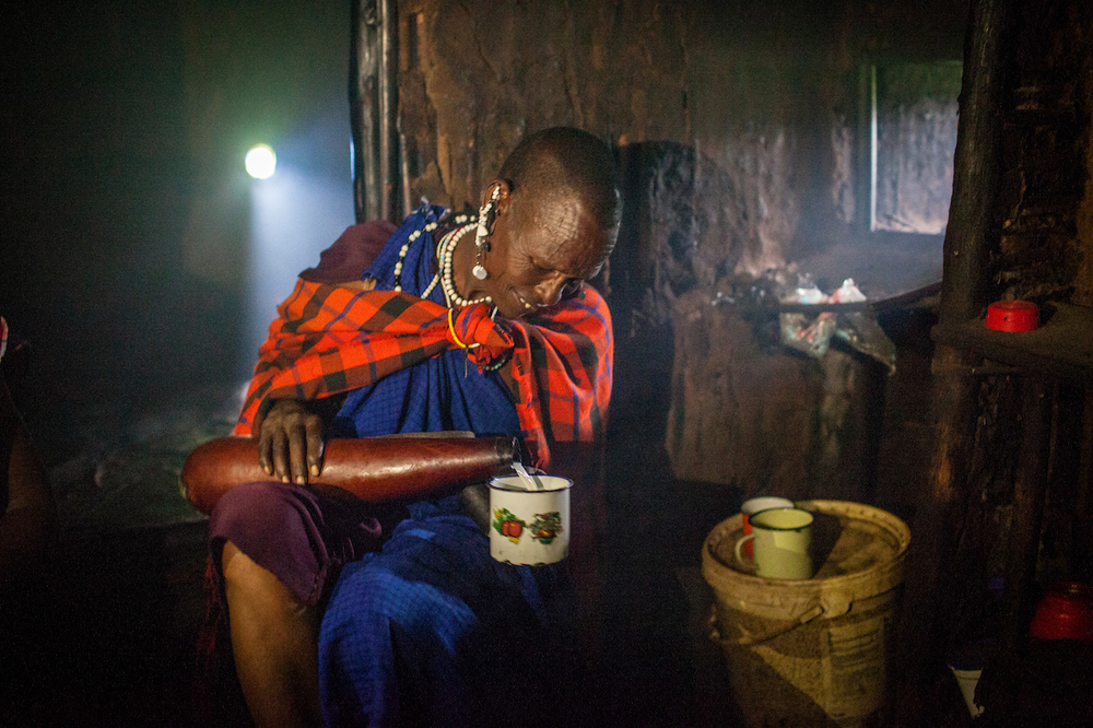 An elder drinking milk inside a traditional home. Milk is normally boiled, but some elders prefer the taste of unboiled milk. Drinking unpasteurised milk increases the likelihood of disease and parasite transmission 
