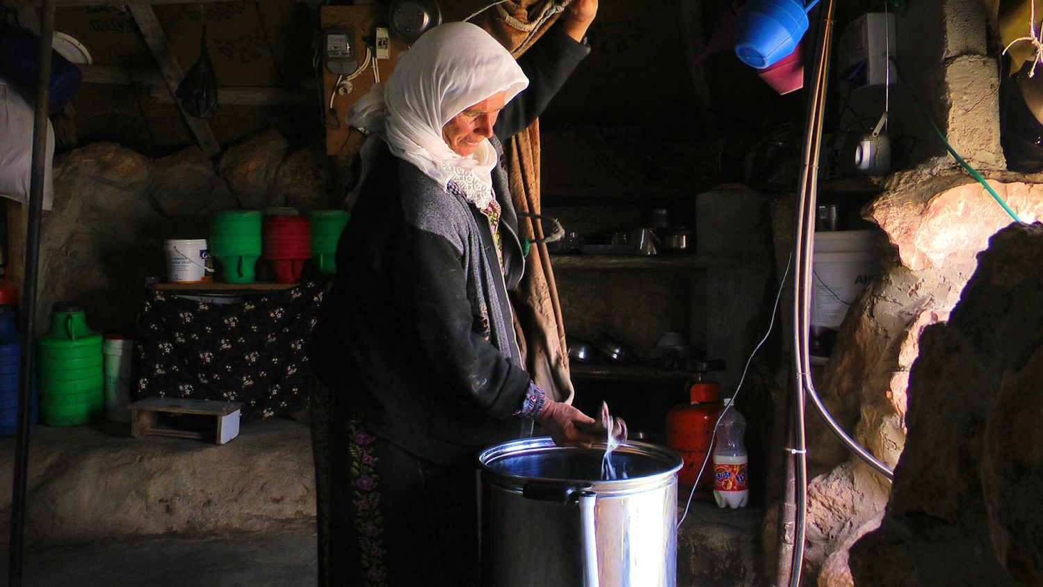 Hajeh Nuzha with a new butter churner in Sha’eb el Buttom village. The use of electric churners and refrigerators not only makes it easier to produce butter and cheese, but also leads to better products that sell for higher prices: family incomes have grown by as much as 70 per cent since the electric goods were introduced
