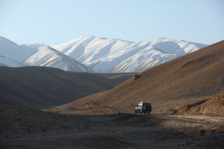 Much of Afghanistan is mountainous and the road networks are poor. As a result, many communities are isolated — especially in winter — and are without electricity. Here a Norwegian Church Aid vehicle follows a hazardous road over a mountain pass to reach a village in Daykundi province as part of its Solar Power project
