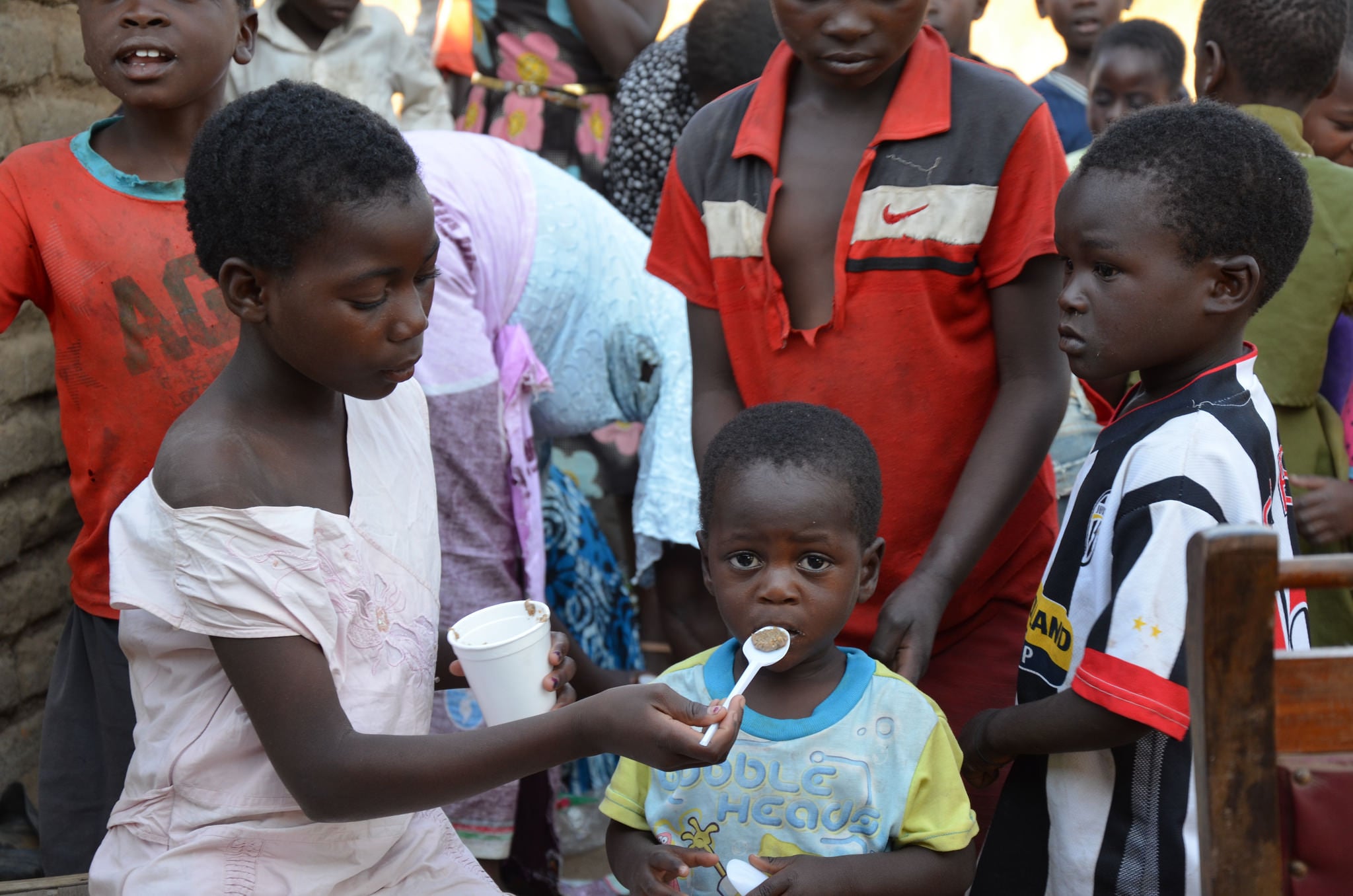 A child is fed the new paste. Pigeon peas are rich in protein. Millet is rich in calcium, iron and folic acid. Groundnuts are rich in protein, fat, iron and zinc, and maize is rich in starch
