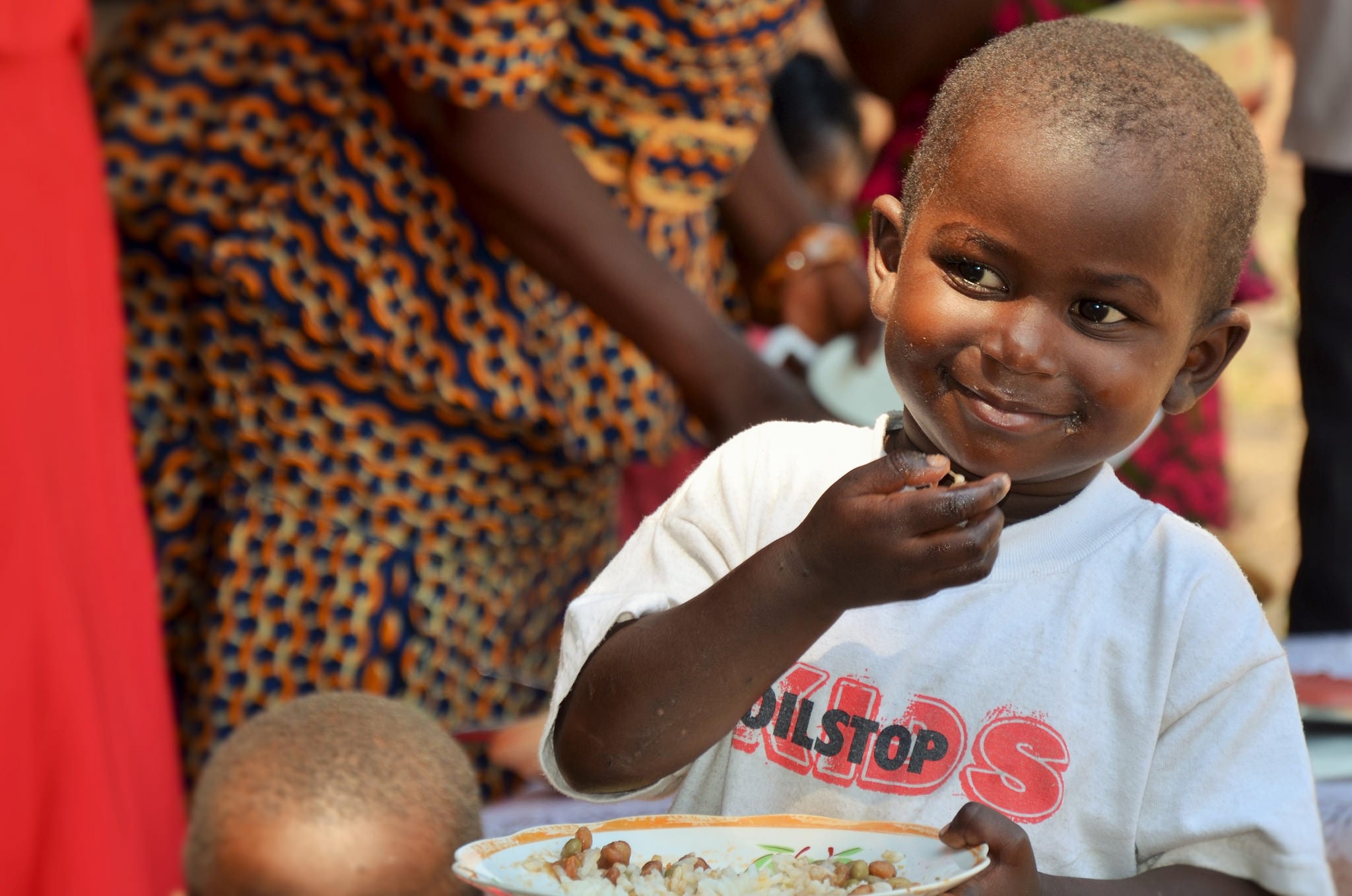 Boy eating pigeon peas and cereal. If this recipe is effective, Nkhoma Hospital wants to turn it into a treatment for malnutrition and aflatoxin poisoning

