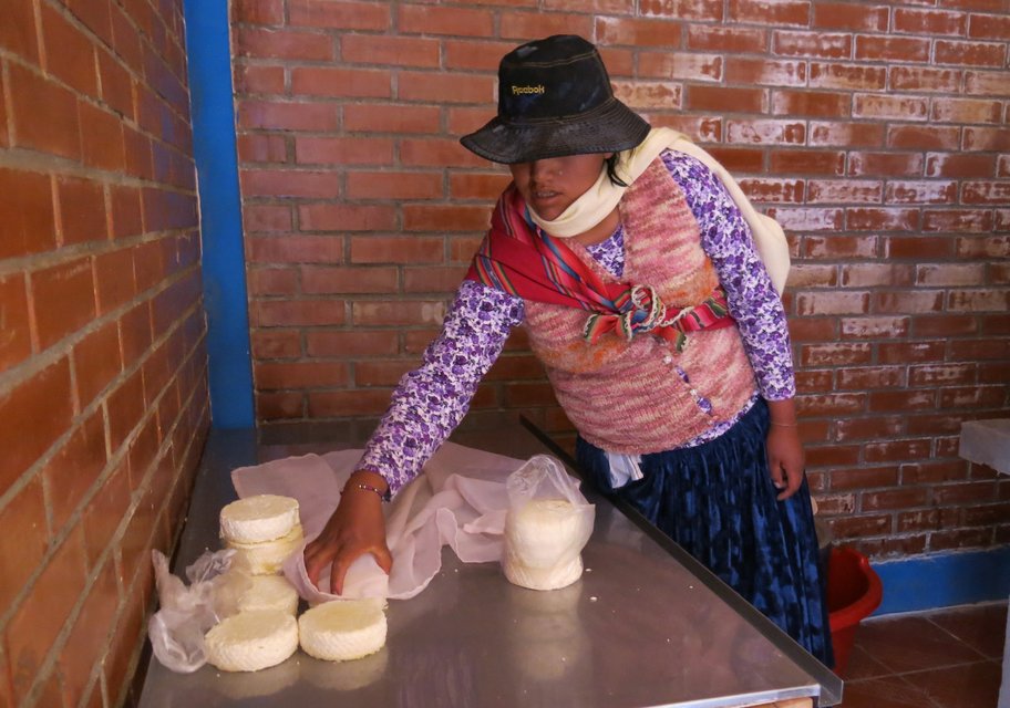 A girl collects cheese produced in the centre. Local women say they would like to learn about new tools and techniques to further improve productivity. 
