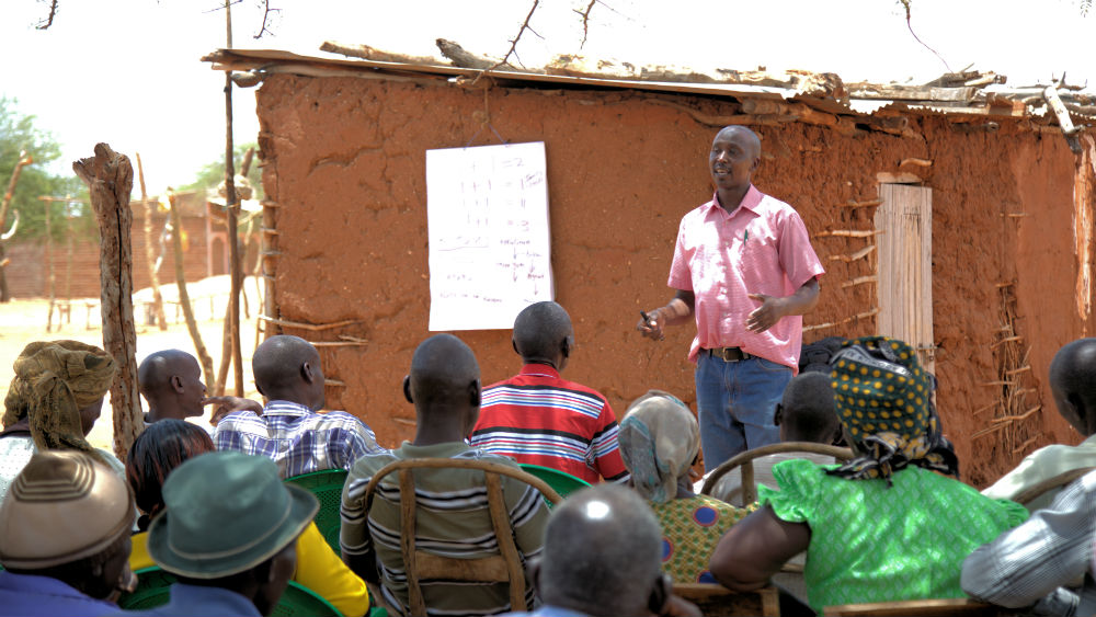 To help them cope with the situation, Farm Africa has initiated training projects and here project officer, Onesmus, is taking farmers through a session to equip them with knowledge on how to adapt
