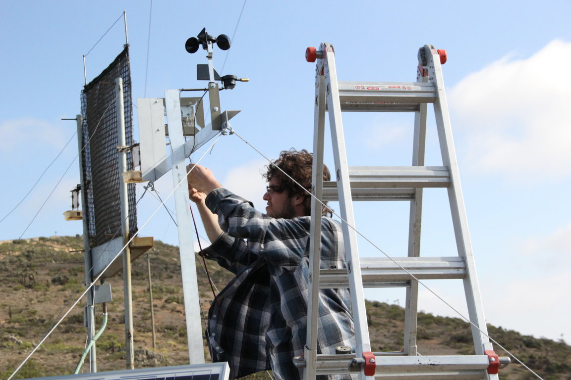 The scientists also are testing different meshes in small fog catchers to find out which performs best. Here, Marco Salinas from the University of the Andes installs instrumentation that will measure the velocity of the wind and the water content in fog.  
