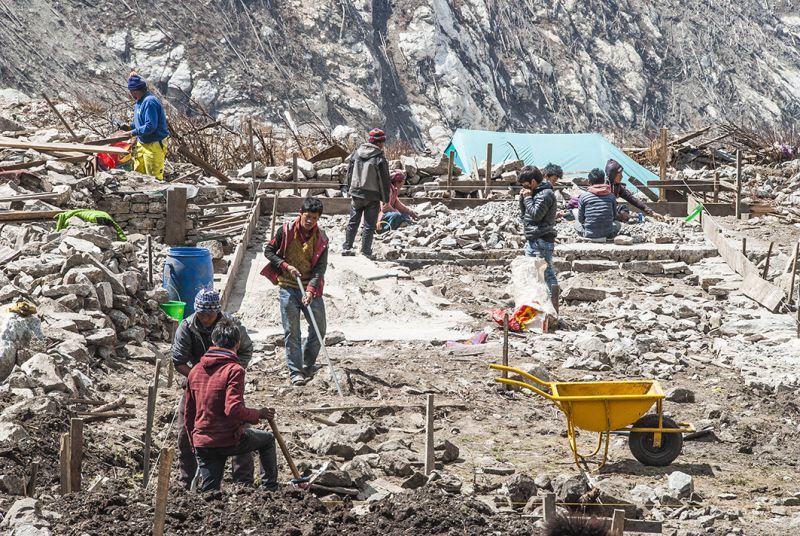 Langtang villagers rebuild homes beside landslide debris. Scientists fear more avalanches are in the making on the slopes high above the valley. But people have nowhere else to go because their only assets and land have been destroyed
