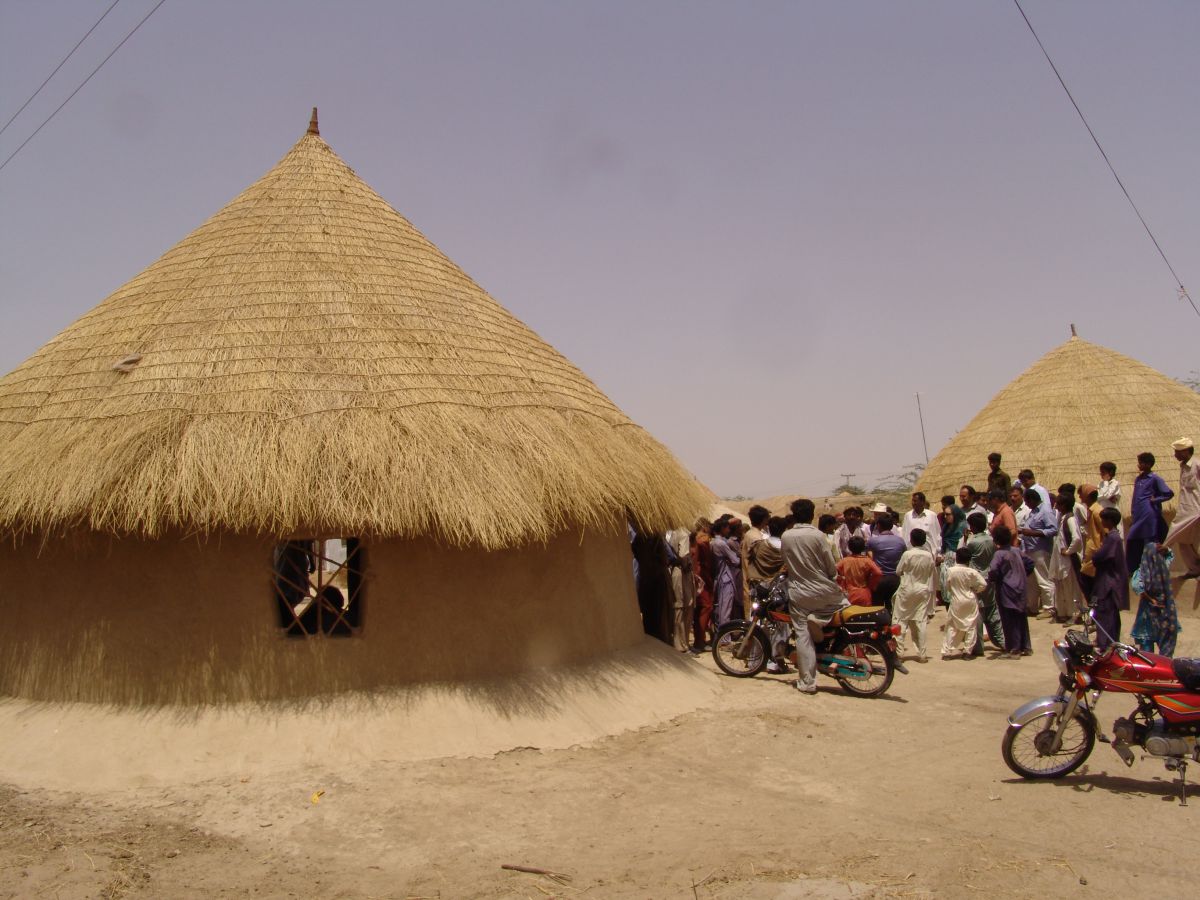 A spacious traditional house for a family in a Hindi village reconstructed by the NGO HANDS, in Sindh’s Sanghar district. The thatched roof was created by skilled local workers. Most rooves include plastic below the thatch and mud but no plastic was used here so hot air can escape, keeping the building cool

