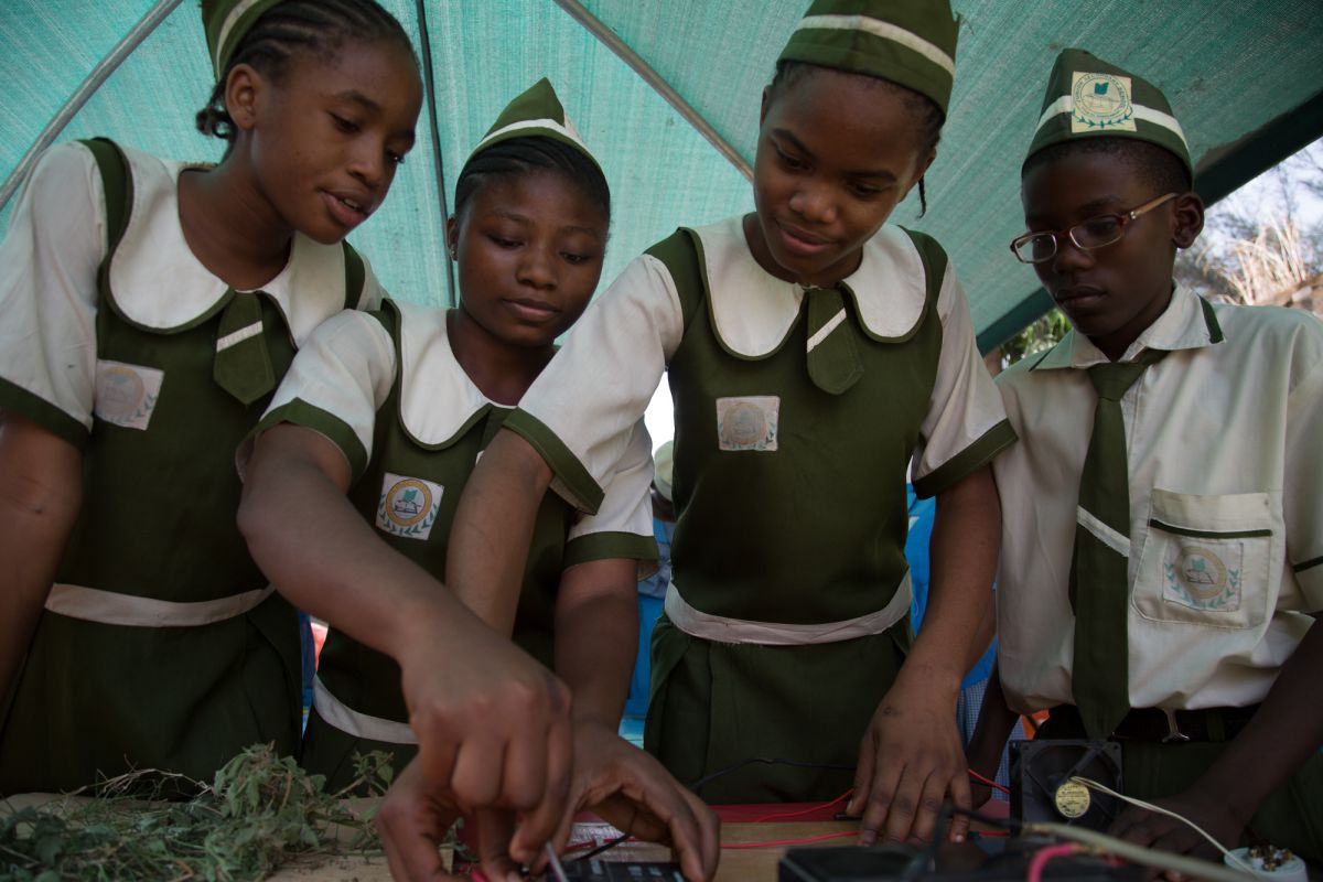 Pupils from Junior Secondary School Area 11 with their solar power project, demonstrating how solar cells can power household fittings, including a fan and light bulb. Uhegbu Ljeoma (far left) says the project opened her eyes to the world of science. She is now determined to pursue a career in technology
