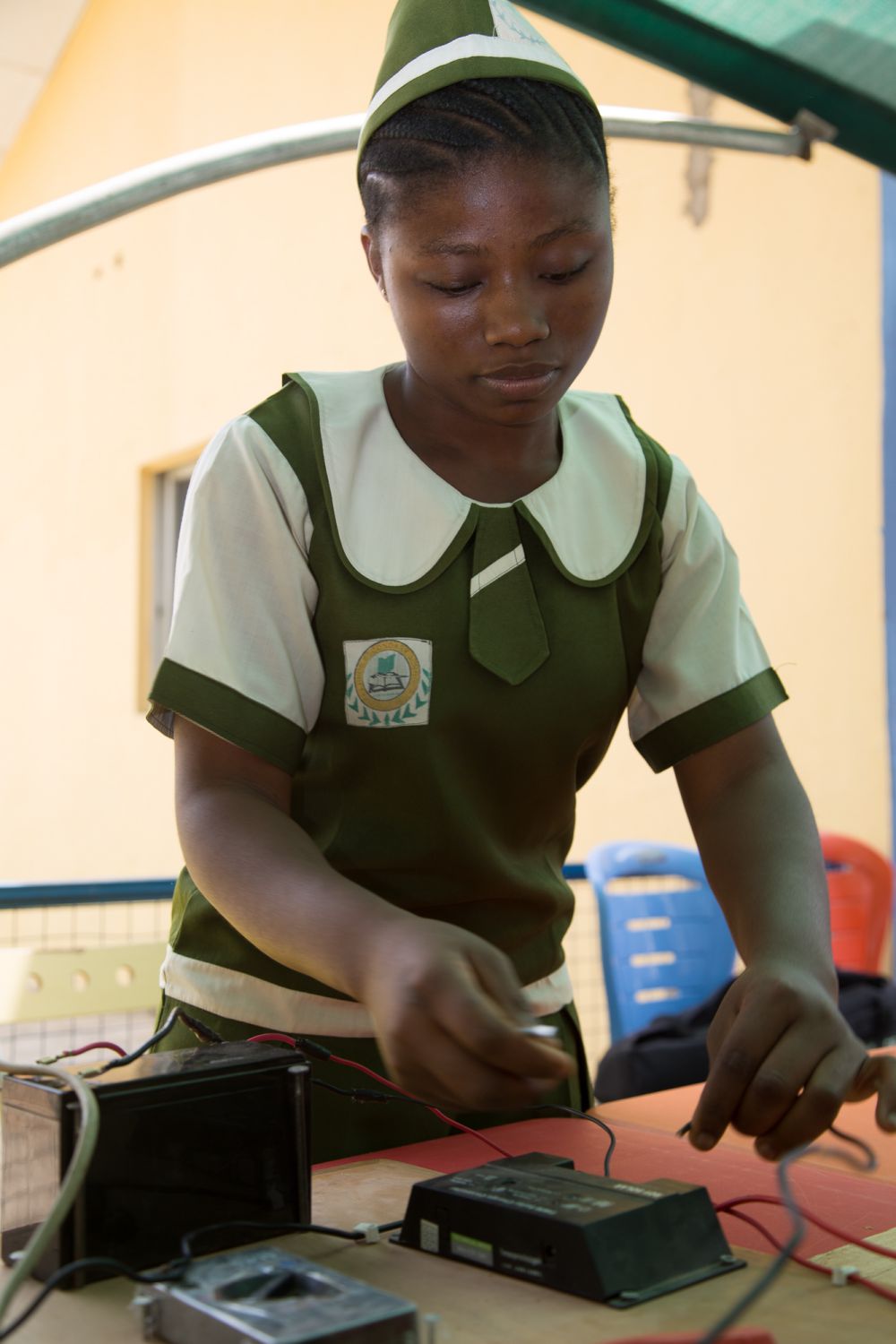 A pupil wires a solar cell, an important element within the science project her class is carrying out on domestic solar power

