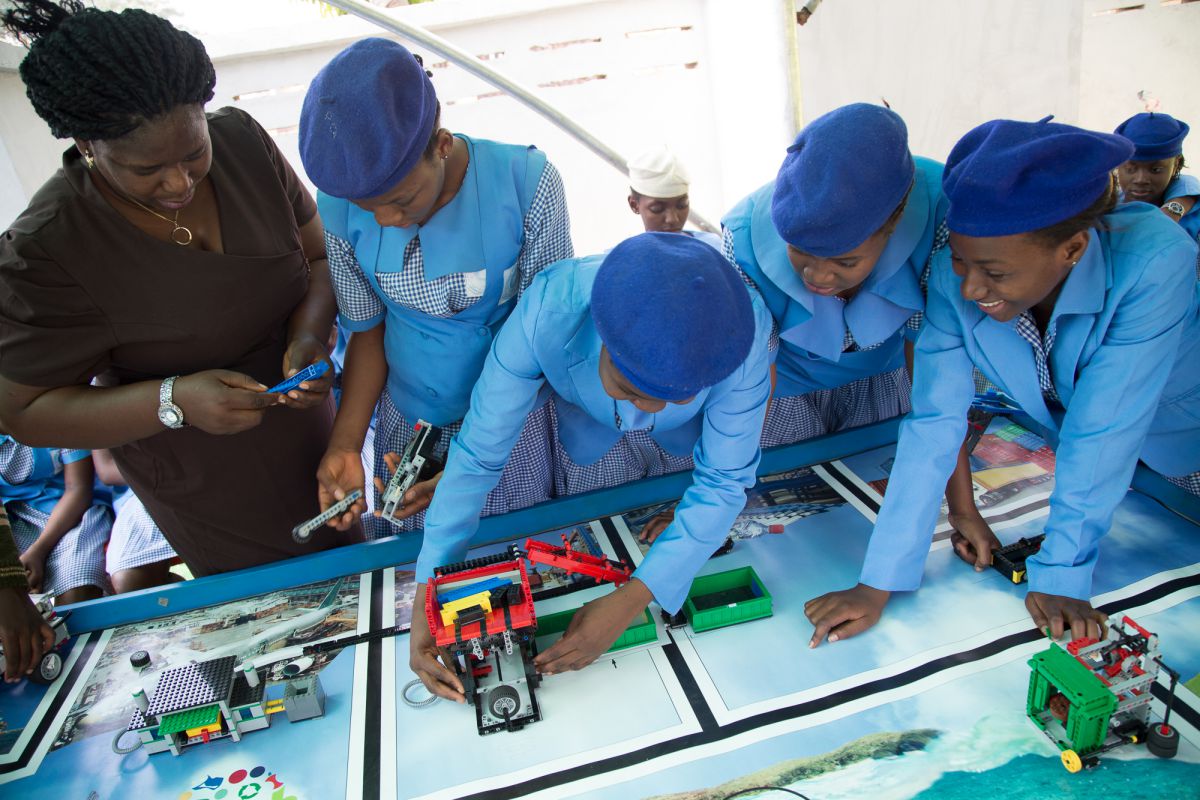 Stella Uzochukwu-Denis from the Odyssey Educational Foundation shows girls from Government Girls Secondary School Dutse how to build a robot. The foundation hosted the First Lego League challenge, in Abuja. In this competition, students programmed Lego robots donated by the toy firm to achieve a waste-based goal
