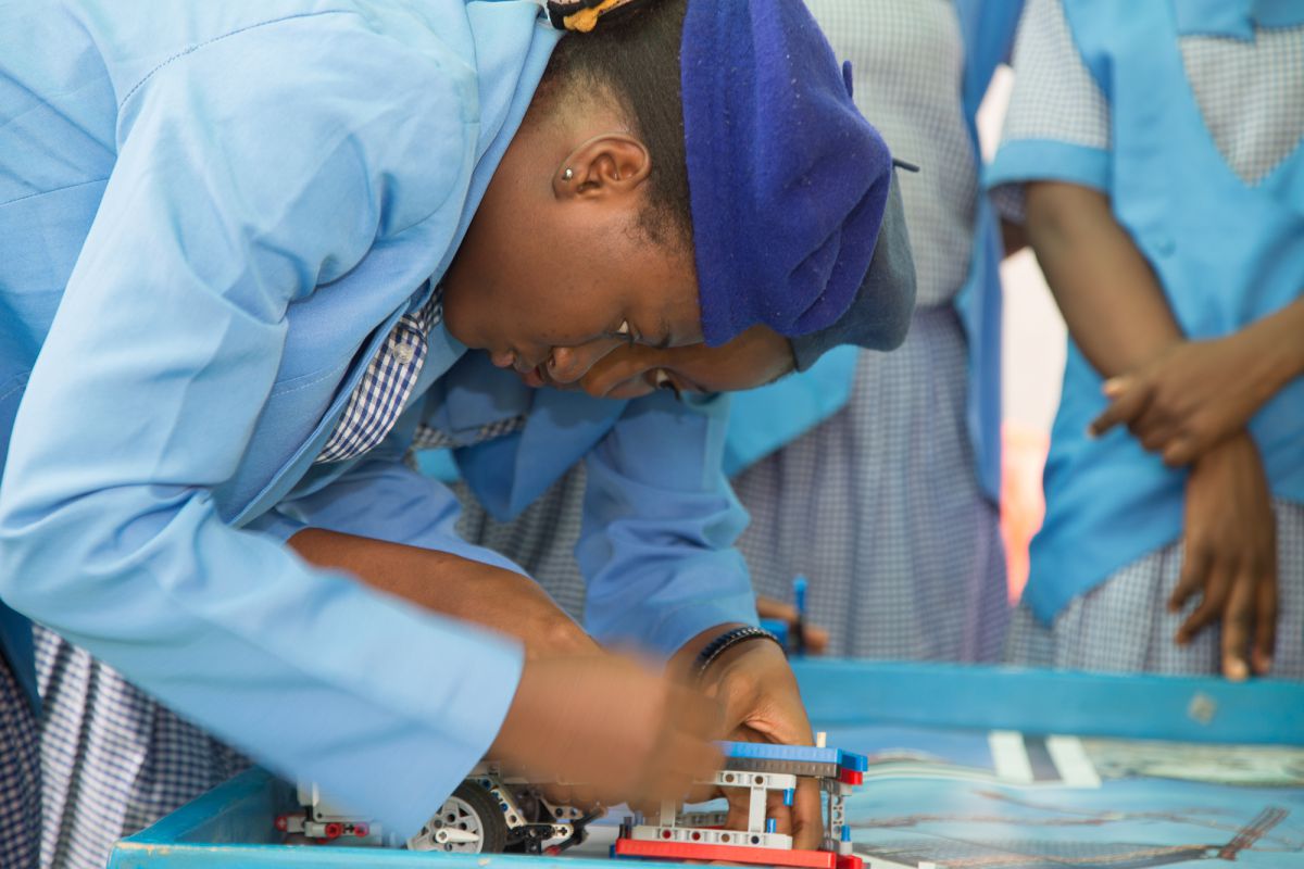 Sixteen-year-old Lawal Alaifan Karimah makes sure the robot is programmed correctly so that it moves across the board picking up garbage and dropping it off in the correct places. She says that a girl can do whatever a boy can 

