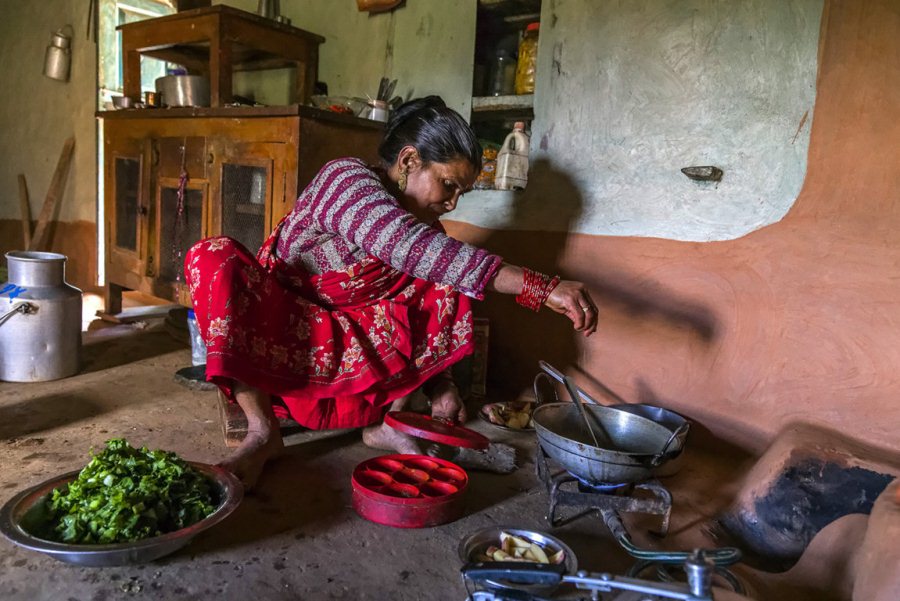 Cooking using gas from a biogas system. Human urine and faeces are mixed with water and collected in an underground pit, where they produce methane that is carried through a narrow pipe into this gas stove
