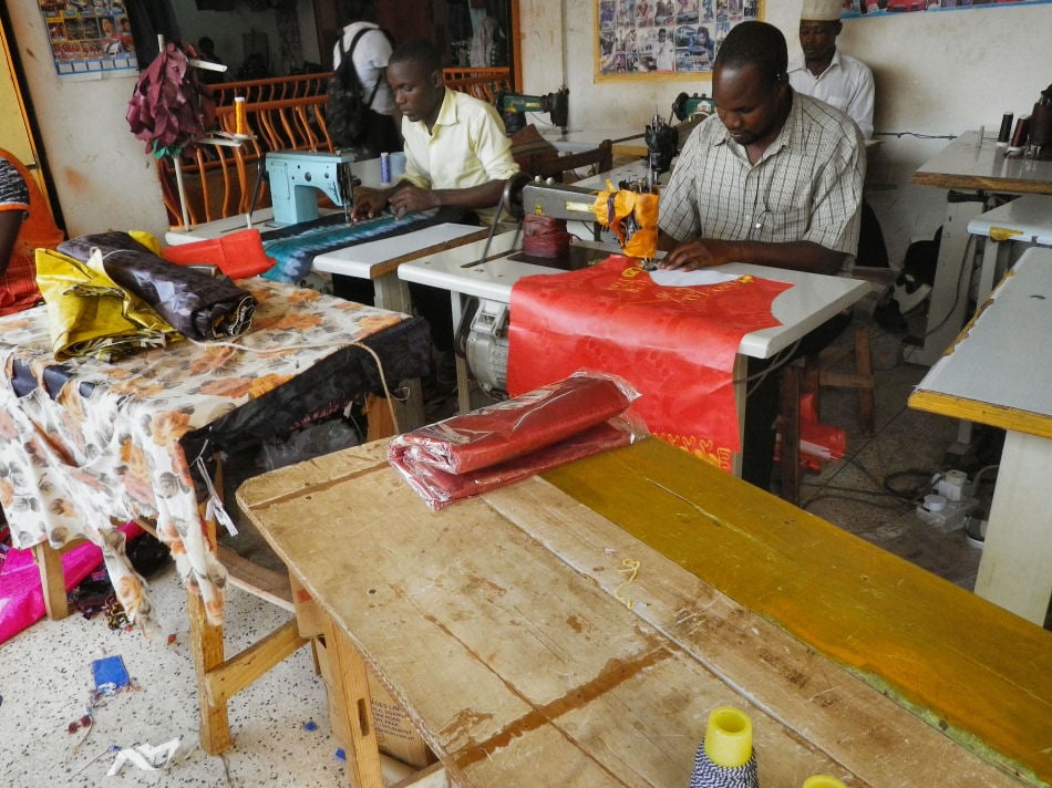 Refugees working alongside Ugandans as tailors in Kampala.