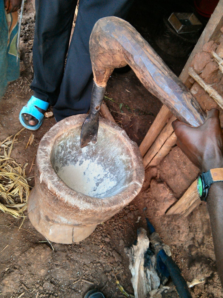 A traditional Congolese cassava grinder crafted by a refugee using handmade tools in Kyangwali refugee settlement. The refugee now makes a living selling these wooden grinders to other Congolese refugees in Kyangwali.
