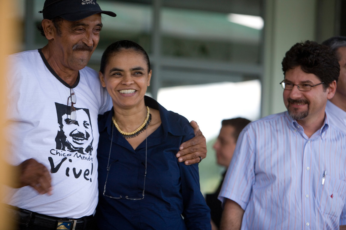 A rubber tapper and cousin of Chico Mendes hugging the then environment minister Marina Silva at the opening of the Natex condom factory in 2008 
