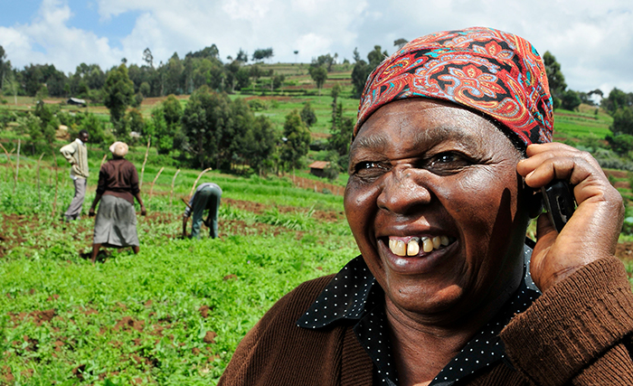 Kenyan lady farmer on phone