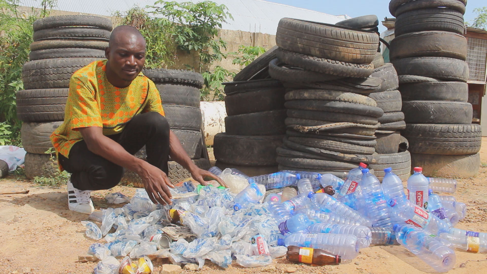 Picture 1-Francis Kantavooro sorting out plastic bottles at his factory 1